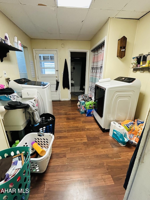 washroom featuring wood finished floors and washing machine and dryer