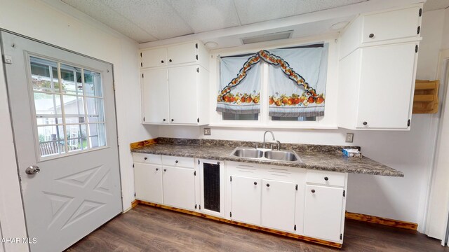 2822 5th Ave, Altoona, PA 16602 - kitchen with a sink, dark wood-style flooring, white cabinetry, and dark countertops
