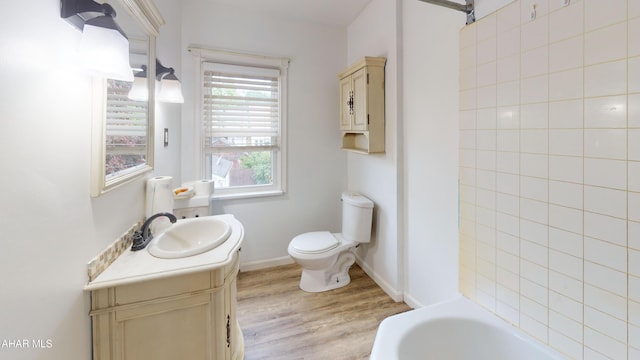2822 5th Ave, Altoona, PA 16602 - bathroom featuring vanity, wood finished floors, toilet, and baseboards