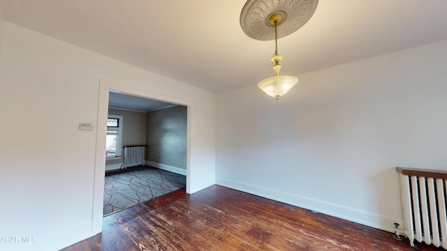 2822 5th Ave, Altoona, PA 16602 - empty room featuring radiator heating unit, wood-type flooring, and baseboards