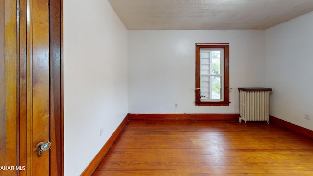 2822 5th Ave, Altoona, PA 16602 - spare room featuring radiator, hardwood / wood-style flooring, and baseboards