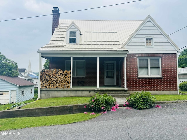 14 W 2nd St, Everett, PA 15537 - view of front of property with brick siding, covered porch, and a chimney