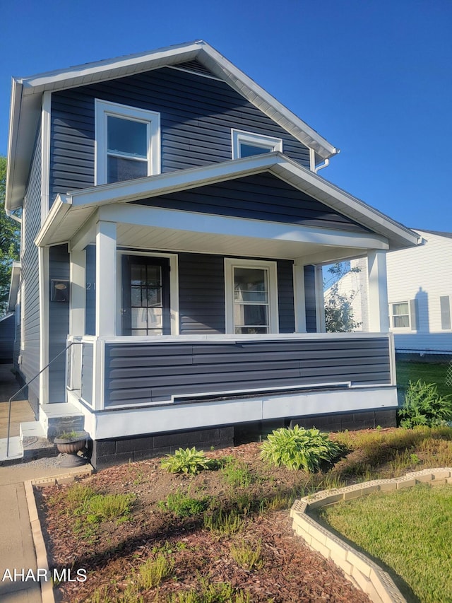 view of side of property featuring covered porch