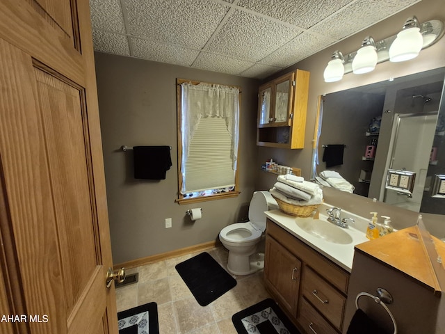 bathroom with baseboards, vanity, tile patterned floors, and toilet