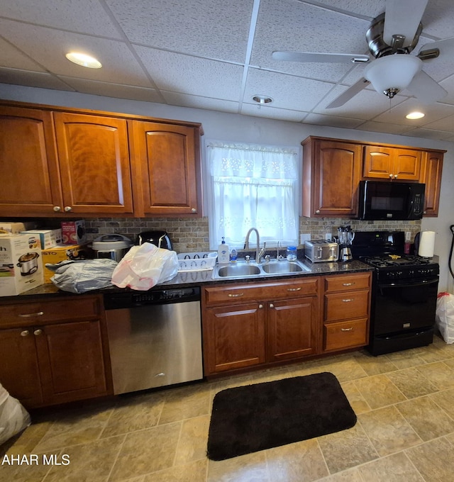kitchen with a sink, tasteful backsplash, dark countertops, ceiling fan, and black appliances