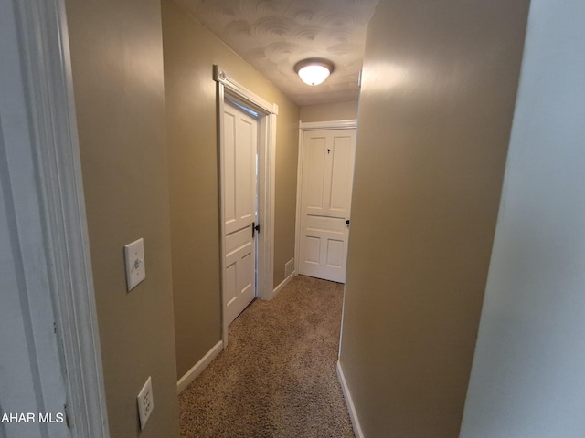 corridor featuring carpet floors and baseboards