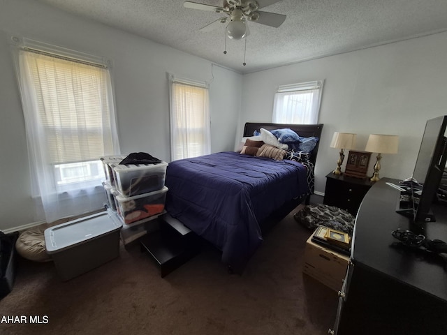 bedroom with carpet, a ceiling fan, and a textured ceiling