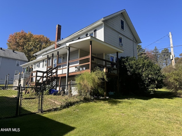 rear view of house with a lawn