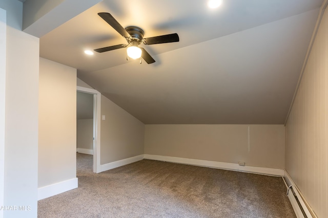 additional living space with a baseboard radiator, vaulted ceiling, light colored carpet, and ceiling fan