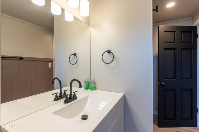 bathroom featuring vanity and crown molding