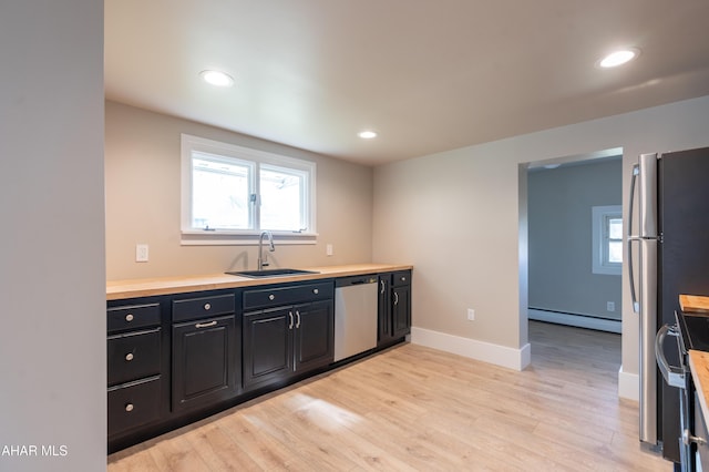 kitchen featuring a baseboard radiator, stainless steel appliances, sink, and light hardwood / wood-style flooring