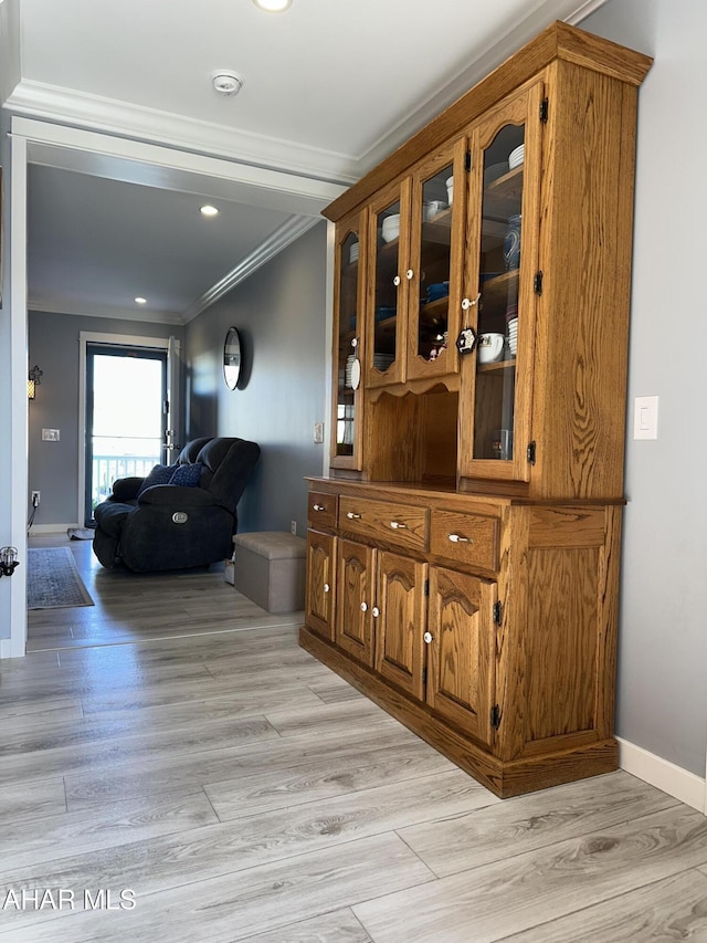 hallway featuring recessed lighting, baseboards, ornamental molding, and light wood finished floors