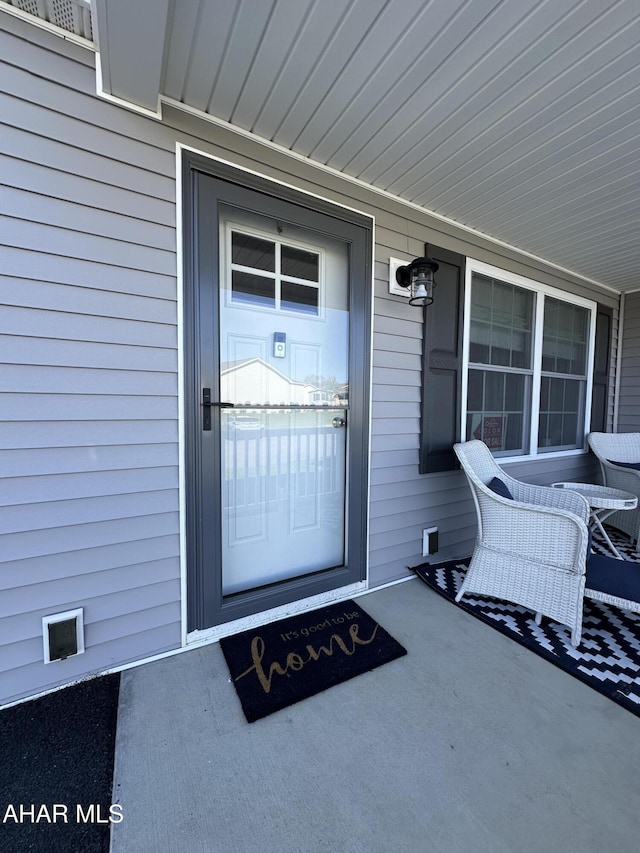 view of exterior entry featuring a porch