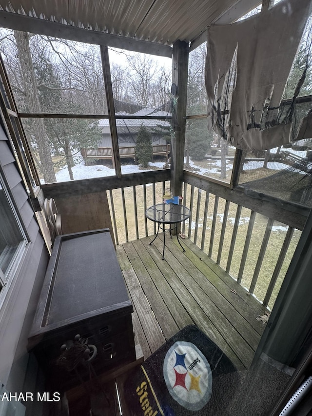 snow covered deck with a lawn