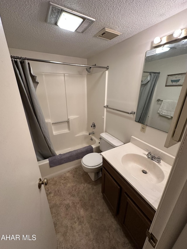 full bathroom with vanity, shower / tub combo with curtain, a textured ceiling, and toilet