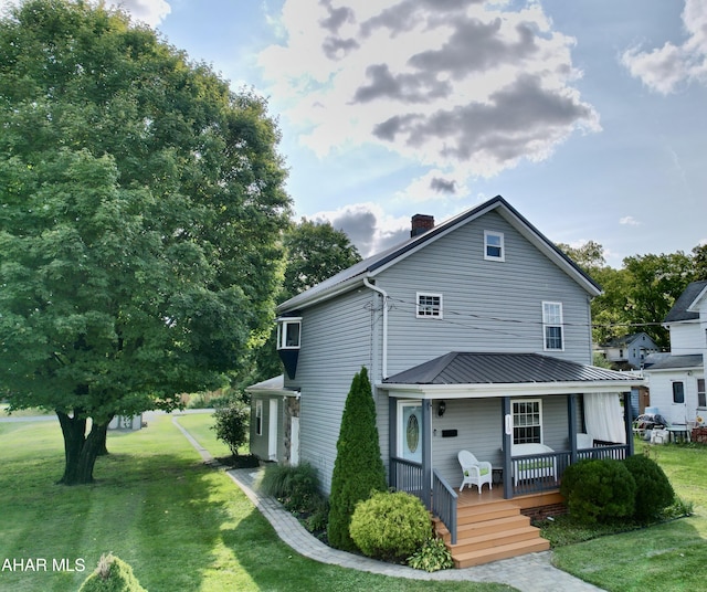 view of front of home featuring covered porch and a front lawn