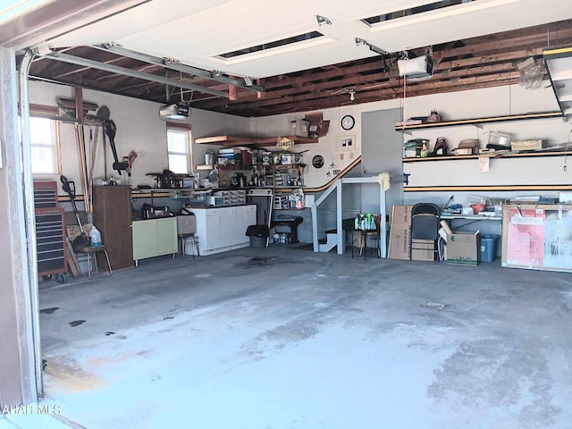 garage with a workshop area and a garage door opener