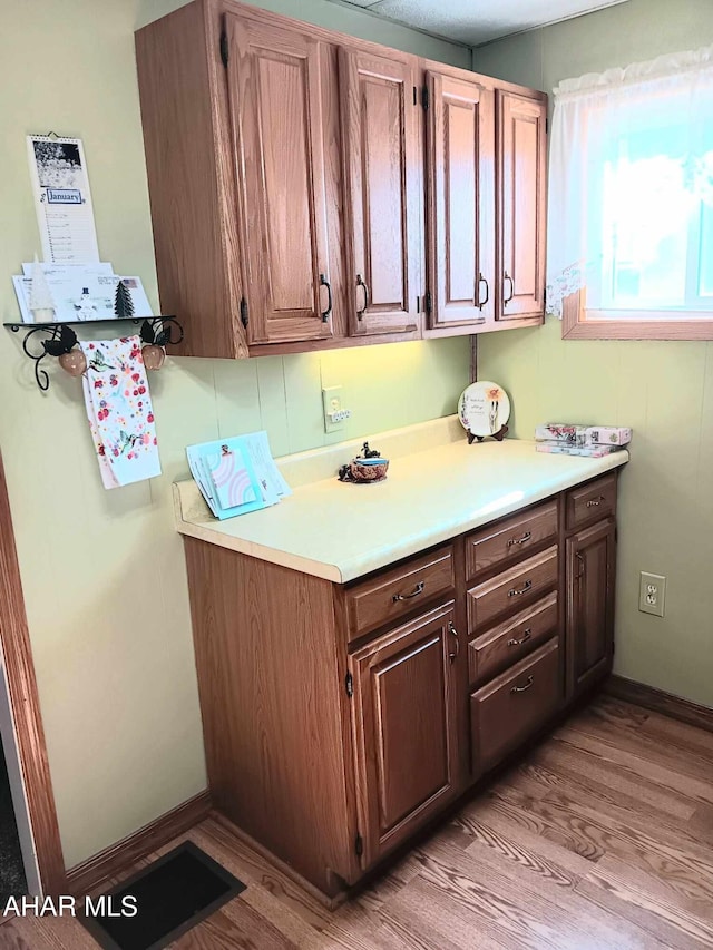 kitchen featuring light wood-type flooring and light countertops