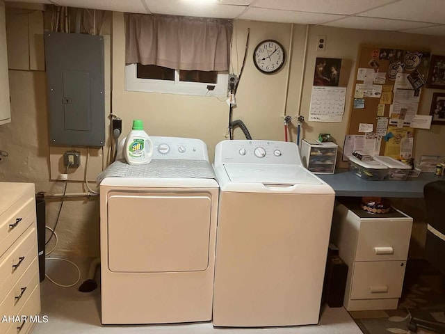 laundry area with electric panel and washing machine and clothes dryer