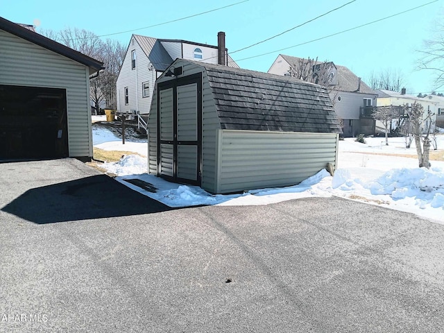 exterior space featuring a storage shed and an outdoor structure