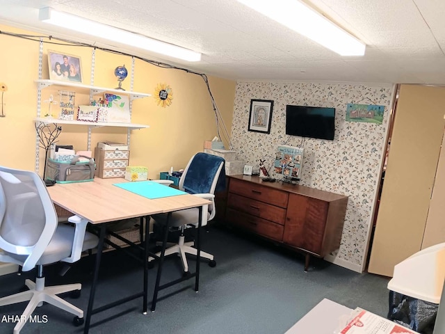 office space with a textured ceiling and wallpapered walls