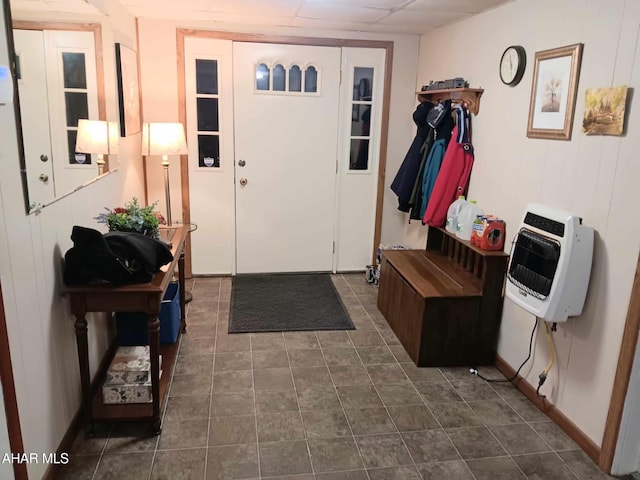 tiled foyer entrance with heating unit and a drop ceiling