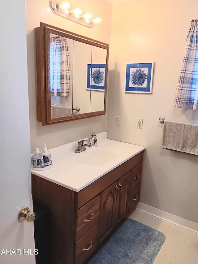 bathroom featuring baseboards and vanity