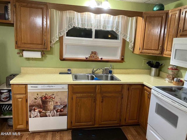 kitchen featuring white appliances, dark wood-type flooring, and sink