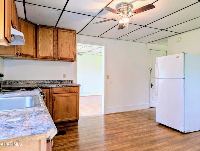 157 Cove Rd, Buffalo Mills, PA 15534 - kitchen with freestanding refrigerator, brown cabinets, extractor fan, wood finished floors, and range