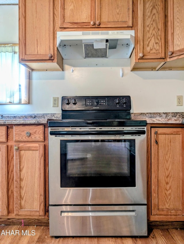 157 Cove Rd, Buffalo Mills, PA 15534 - kitchen featuring stainless steel range with electric cooktop, ventilation hood, light wood-type flooring, and light countertops