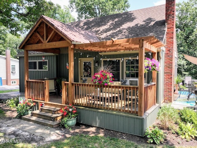 rear view of property with covered porch