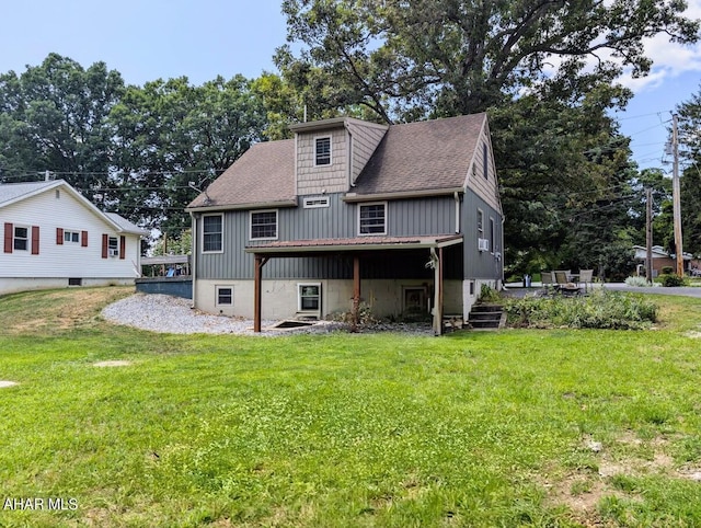 back of house with a lawn