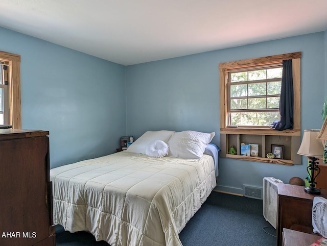 bedroom featuring dark carpet