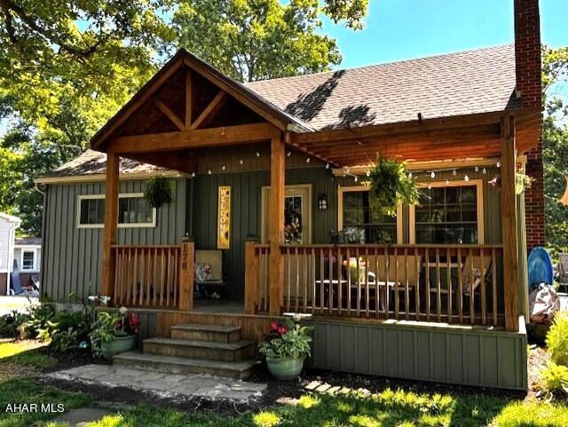 back of property featuring a porch