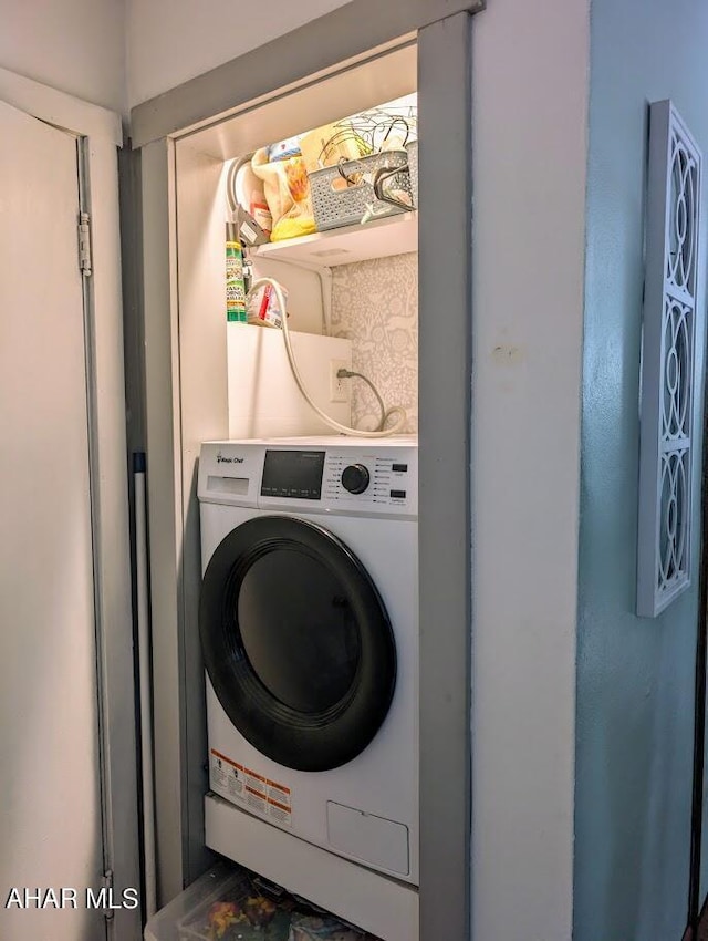 clothes washing area with washer / dryer