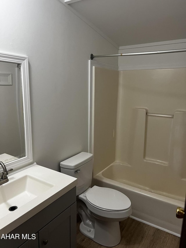 full bathroom featuring vanity, toilet, wood-type flooring, and washtub / shower combination