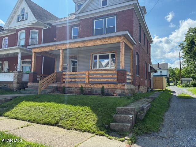 215 N 10th Ave, Altoona, PA 16601 - view of front facade with a porch and brick siding