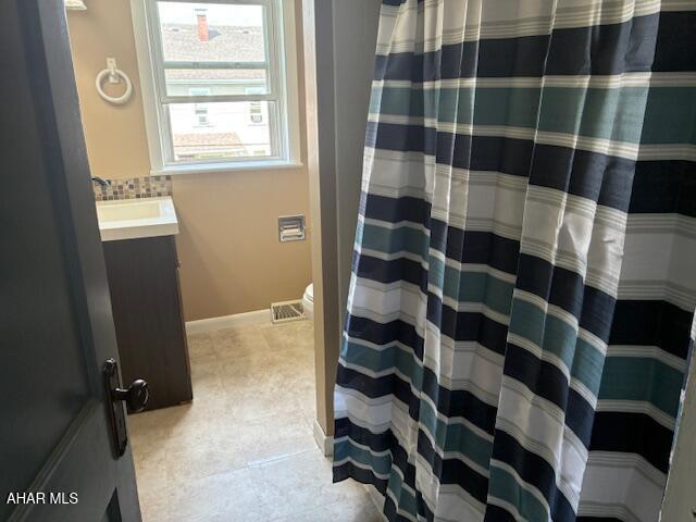 215 N 10th Ave, Altoona, PA 16601 - bathroom with vanity, tile patterned floors, and a shower with curtain