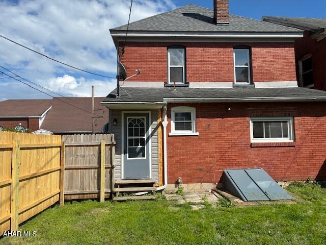 215 N 10th Ave, Altoona, PA 16601 - back of house with brick siding, a chimney, roof with shingles, and entry steps