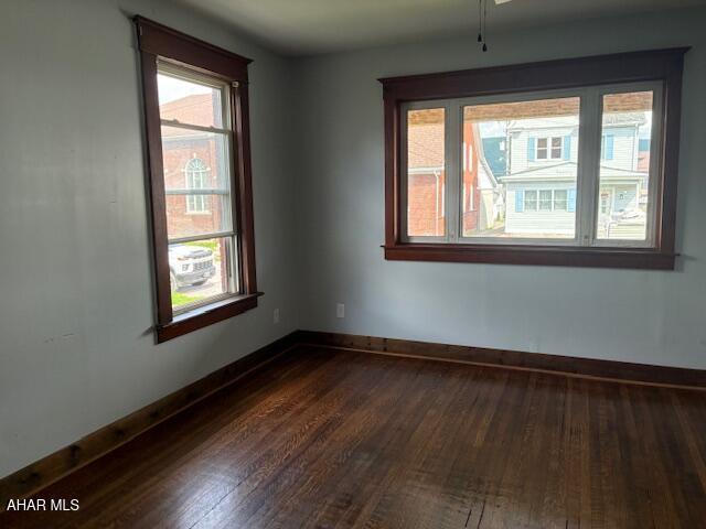 215 N 10th Ave, Altoona, PA 16601 - empty room with dark wood-style flooring and baseboards