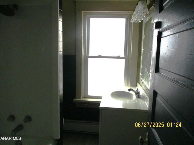 1008 21st Ave, Altoona, PA 16601 - bathroom featuring a baseboard heating unit, vanity, and a tub to relax in