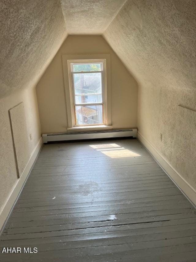 1008 21st Ave, Altoona, PA 16601 - bonus room featuring a textured ceiling, baseboard heating, hardwood / wood-style floors, and vaulted ceiling