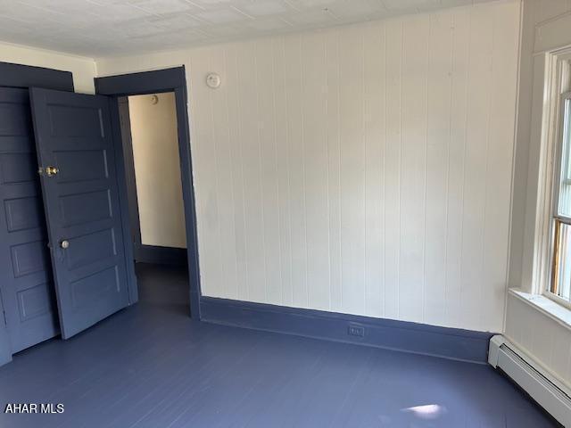 1008 21st Ave, Altoona, PA 16601 - empty room featuring a baseboard radiator and wood finished floors