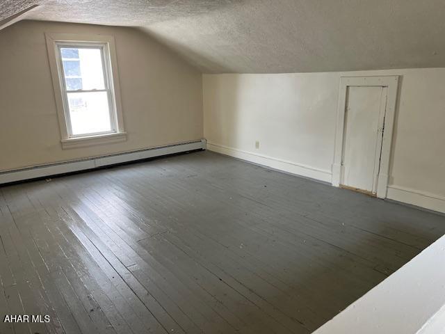 1008 21st Ave, Altoona, PA 16601 - bonus room with baseboard heating, a textured ceiling, wood-type flooring, and vaulted ceiling