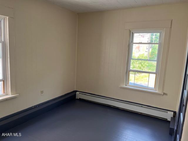 1008 21st Ave, Altoona, PA 16601 - spare room featuring a baseboard radiator and healthy amount of natural light
