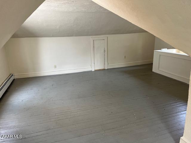 1008 21st Ave, Altoona, PA 16601 - additional living space featuring wood-type flooring, vaulted ceiling, and a textured ceiling