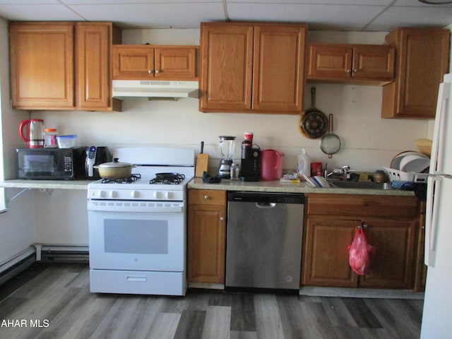 1008 21st Ave, Altoona, PA 16601 - kitchen with white appliances, under cabinet range hood, a paneled ceiling, light countertops, and brown cabinets