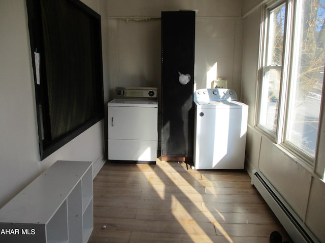 1008 21st Ave, Altoona, PA 16601 - washroom featuring a baseboard heating unit, separate washer and dryer, plenty of natural light, and light wood-type flooring