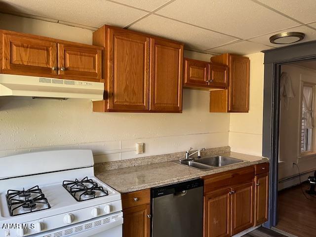 1008 21st Ave, Altoona, PA 16601 - kitchen featuring stainless steel dishwasher, white range with gas cooktop, under cabinet range hood, a baseboard heating unit, and a paneled ceiling