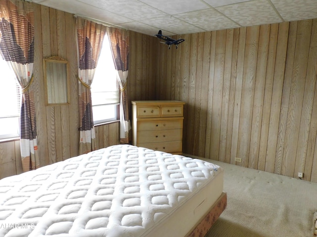 carpeted bedroom with wooden walls